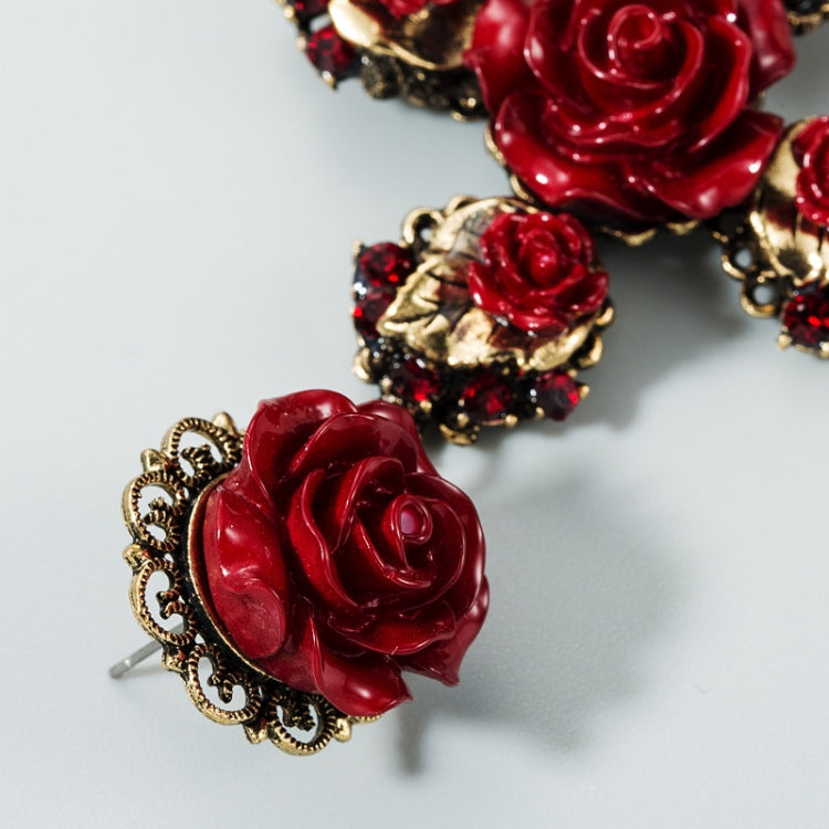 Red rose cross earrings with gold-tone filigree and red jeweled accents