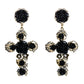 Pair of black rose cross long dangle earrings with gold-tone accents and rhinestones