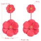 Red triple-flower drop earrings with gold-tone centers, long dangling alloy design