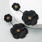 Black flower drop earrings with gold-tone centers, long dangling alloy design
