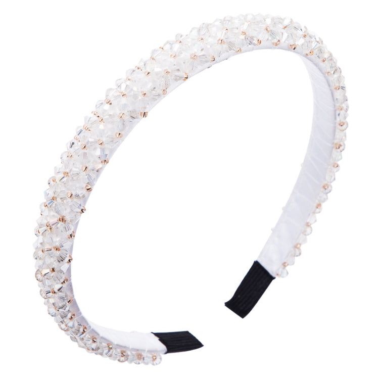 Crystal beaded fabric headband with white stones and black ends on a wide band