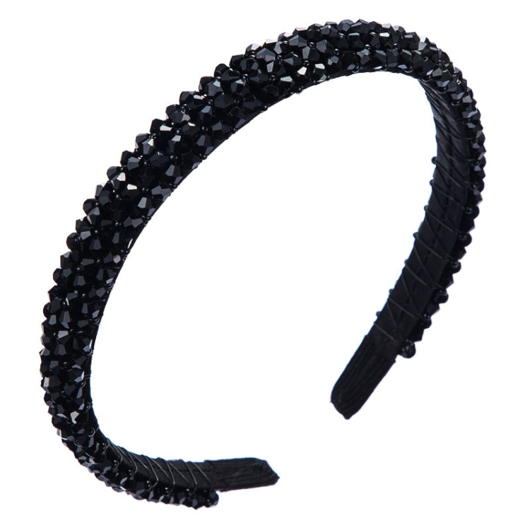 Black crystal beaded fabric headband with black fabric tips and a curved band