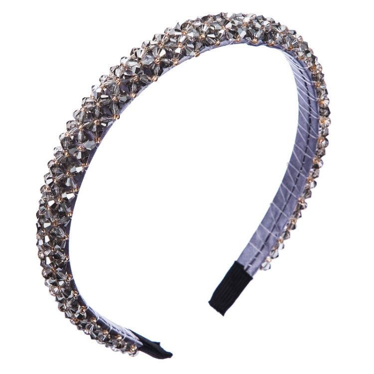 Gray crystal beaded fabric headband with dark fabric tips and a curved shape