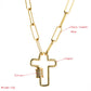 Gold-tone cross pendant necklace with centered zircon bar detail and long link chain