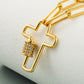 Gold-tone cross pendant necklace close-up with zircon stone column and link chain