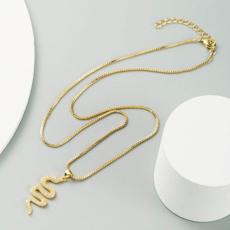 Gold snake pendant necklace with zircon-studded pendant and long link chain