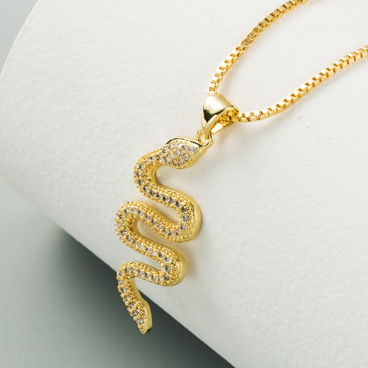 Gold snake-shaped pendant with zircon-studded surface on link chain