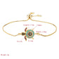 Gold-tone turtle charm bracelet with blue and black zircon-stone inlay and small colored accents