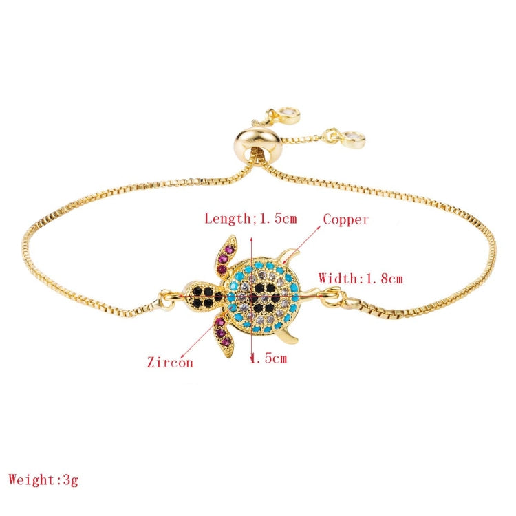 Gold-tone turtle charm bracelet with blue and black zircon-stone inlay and small colored accents