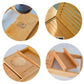 Bamboo bath caddy close-up showing cup holder, tray dividers, and slatted back