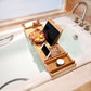 Bamboo bathtub shelf caddy with tablet stand, cup wells, and divided organizer tray