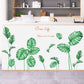 Botanical leaf wall stickers in green, applied across a kitchen wall