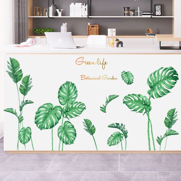 Botanical leaf wall stickers in green, applied across a kitchen wall