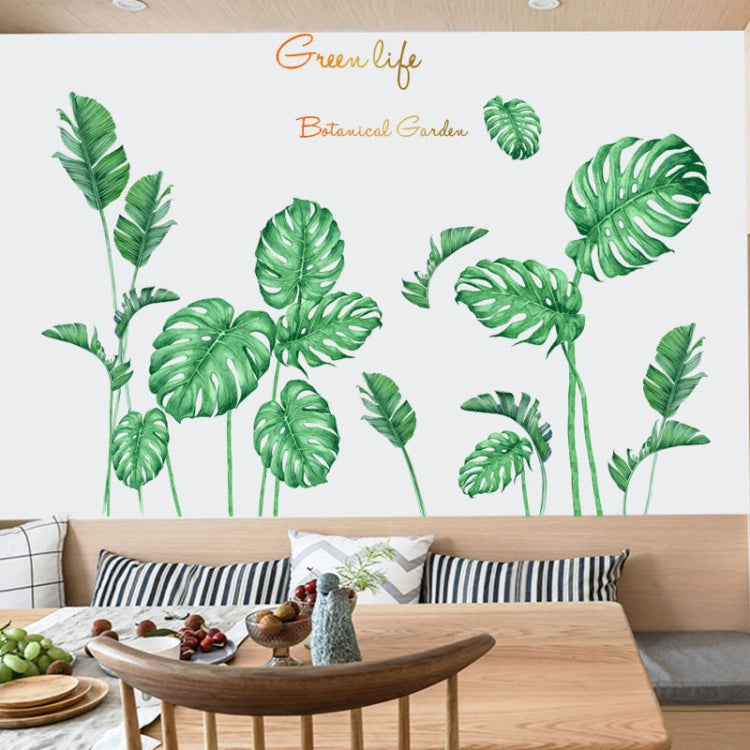 Green botanical leaf wall decals arranged on a living room wall