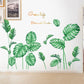 Green tropical leaf wall stickers spread across an indoor wall