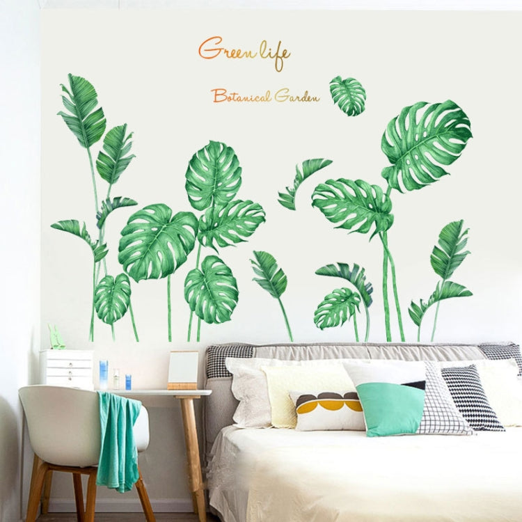 Botanical leaf wall decal set with green monstera-style leaves on a bedroom wall