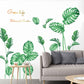 Green tropical leaf wall stickers on a sofa wall with living room seating