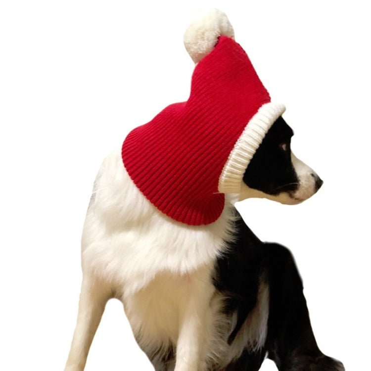 Red wool pet Christmas hat with cream edge and pom-pom, worn on a side-facing dog