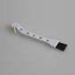 White small vacuum brush with dark bristles and clip end