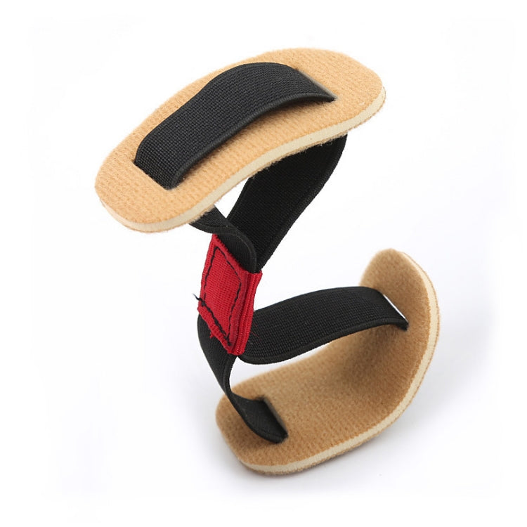 Bunion corrector toe spacer with beige pads, black straps, and red accent