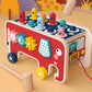 Red wooden pull cart percussion toy with animal pegs, star wheels, and wooden support legs