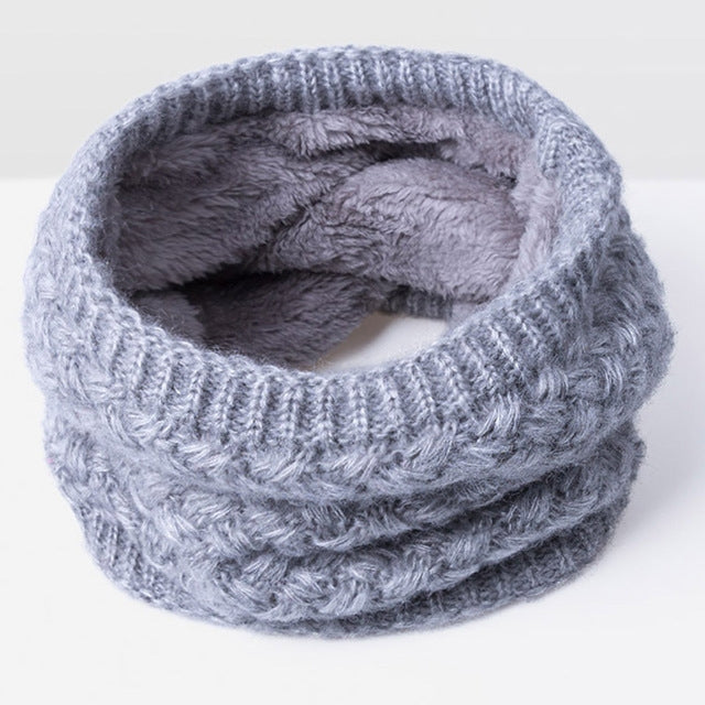 Light gray knit infinity scarf with thick ribbed texture and soft gray fleece lining
