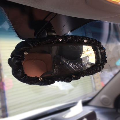 Black leather rearview mirror cover with crystal-studded snap details
