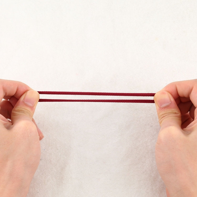 Girls hair rubber bands, burgundy elastic strip held by hands