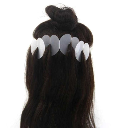 Black wig hair extension with white insulation film tabs clipped along the hair