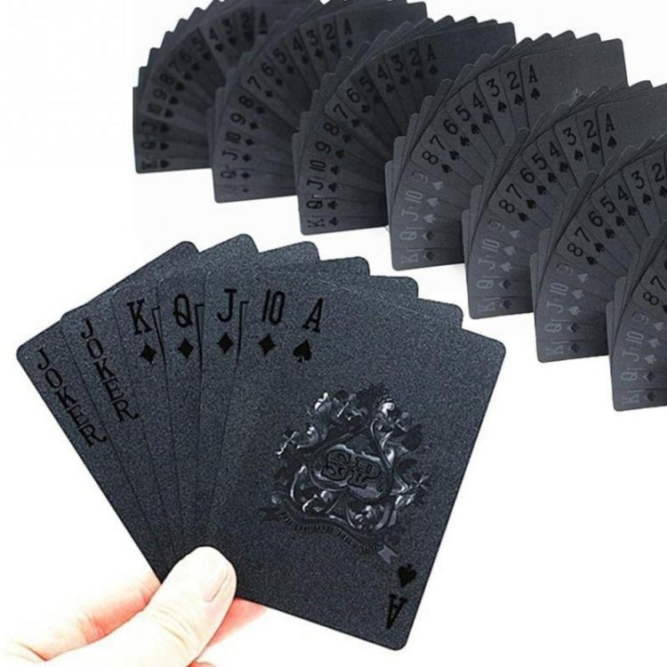 Waterproof plastic playing cards set, hand holding dark deck with ornate crest