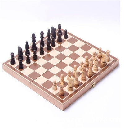 Wooden folding chessboard with black and cream chess pieces on the board