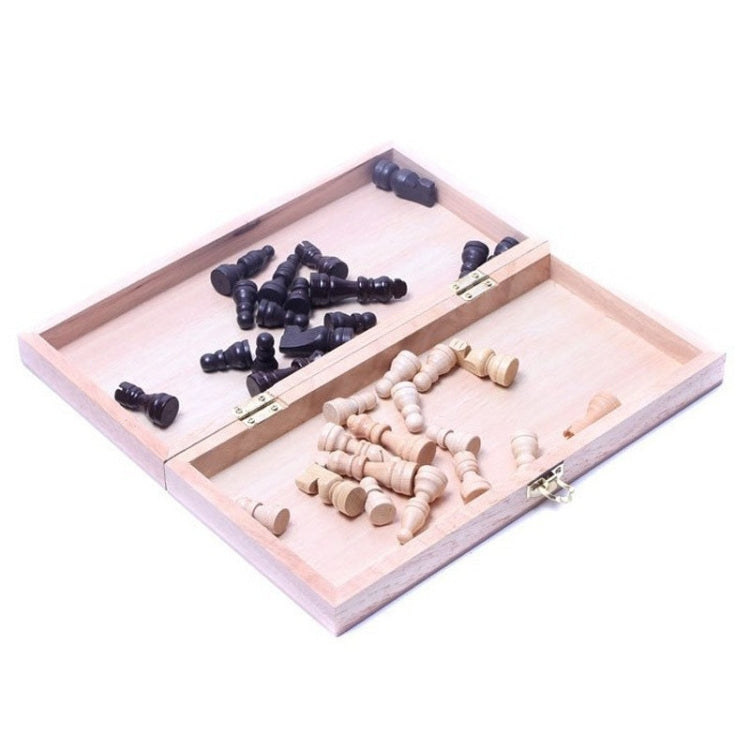Open wooden folding chessboard with black pieces on one side, cream on the other