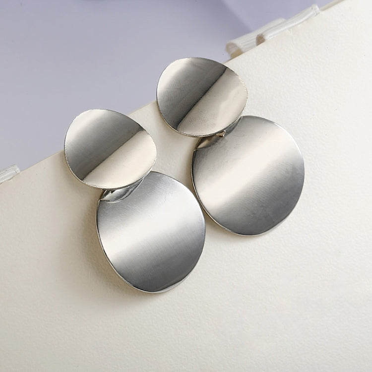 Silver-tone round drop statement earrings with three stacked discs and hook backs.