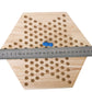 Hexagon wooden checkers board with circular holes and ruler for size comparison