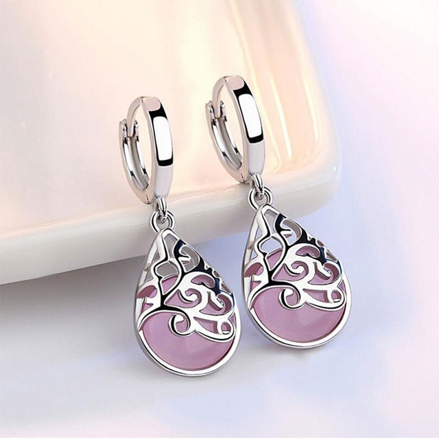 Sterling silver hoop drop earrings with ornate teardrop pendant in pink and white.