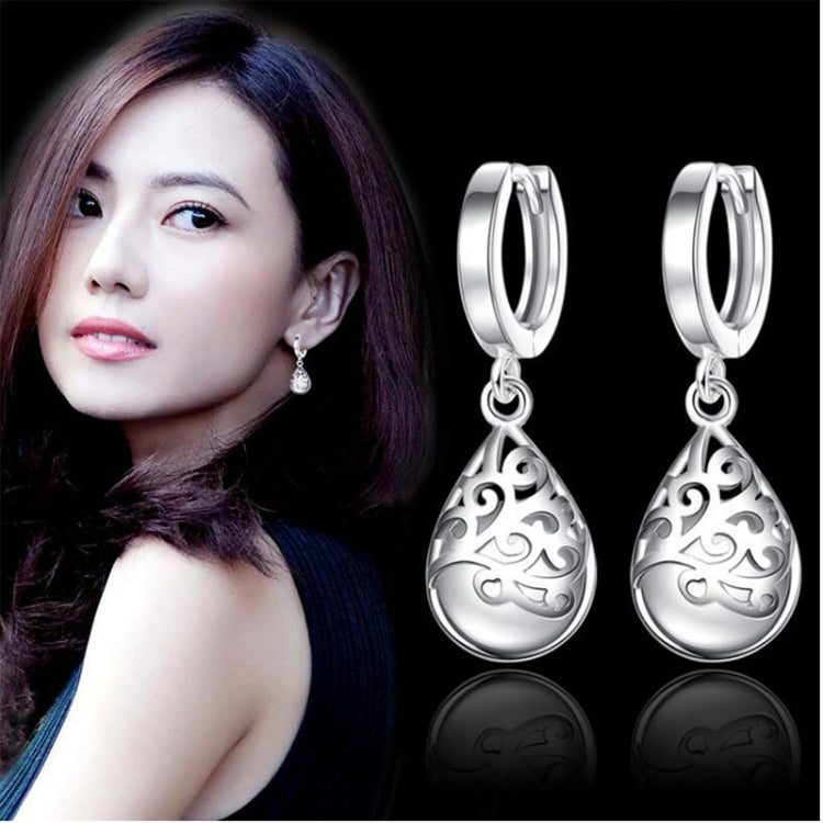 Sterling silver hoop drop earrings with ornate teardrop dangle pendant.