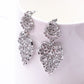 Silver-toned dangling filigree heart-and-flower pendant earrings, layered