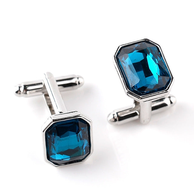 Silver-tone French cufflinks with blue octagon zircon stones, hinged bar backs.