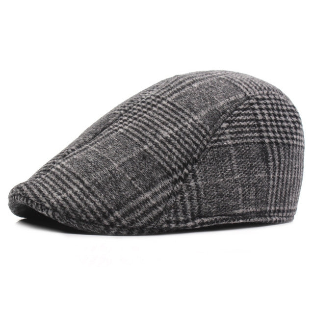 Dark gray flat cap with herringbone-style knit texture and plaid lines