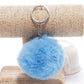 Light blue faux rabbit fur pompon keychain with silver chain and key ring