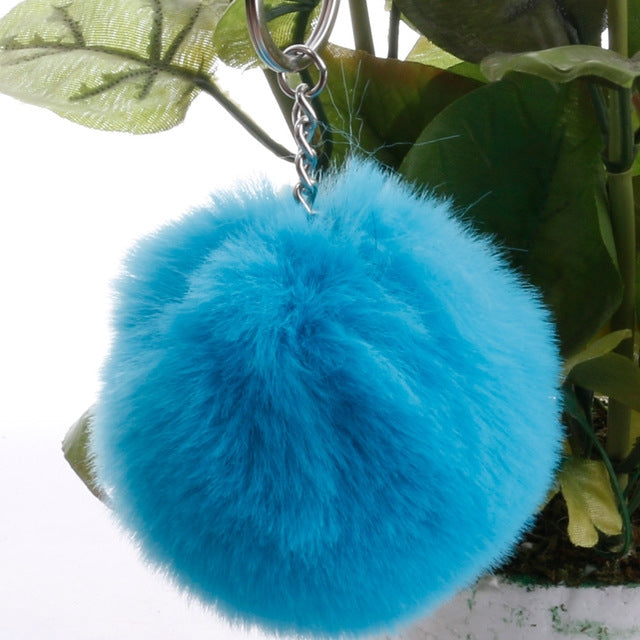 Bright blue faux rabbit fur pompon keychain with silver key ring and chain