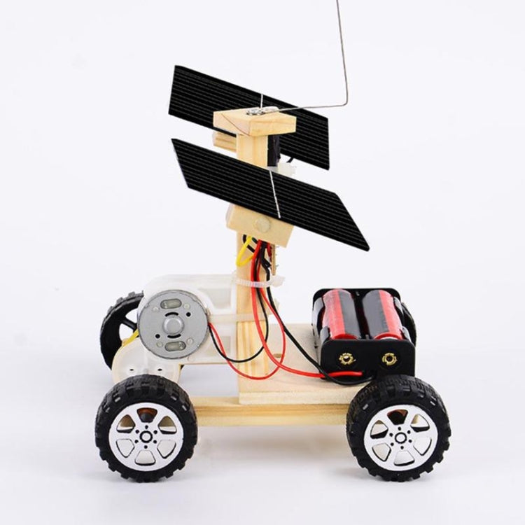 Mini wooden remote control car with solar panels and exposed wiring on the chassis