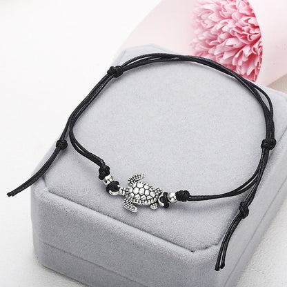 Black wax string anklet with sea turtle charm and small bead accents