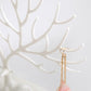 White antler jewelry organizer close-up showing hanging earring hook and chain