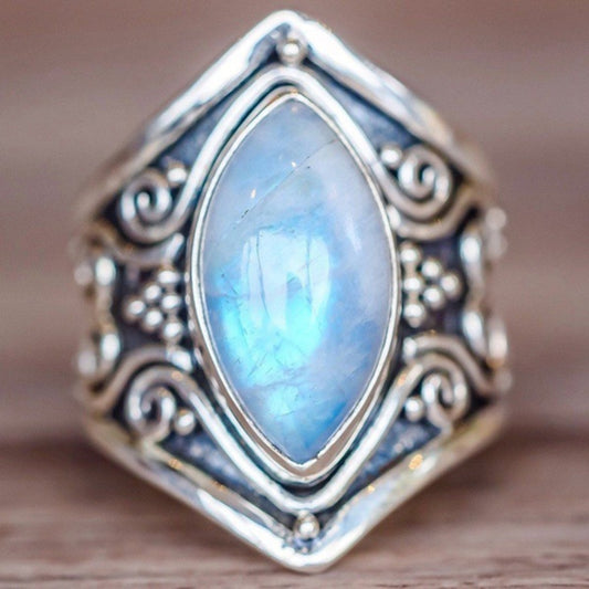 Silver filigree ring with large oval light-blue gemstone, close-up