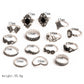 Set of silver-tone ornate rings with black gemstone centers, flat lay with size markings