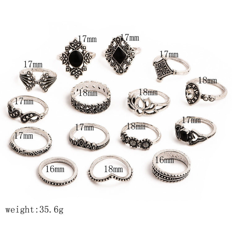 Set of silver-tone ornate rings with black gemstone centers, flat lay with size markings