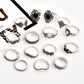 Silver-tone boho-style rings with black and clear stones, arranged in a flat layout