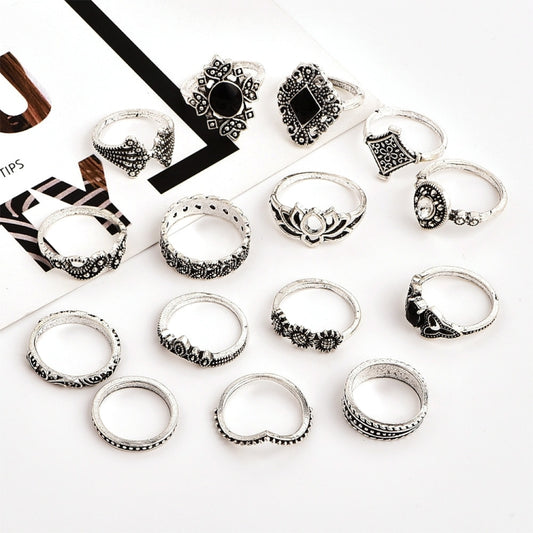 Silver-tone boho-style rings with black and clear stones, arranged in a flat layout