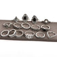 Row of silver-tone ornate rings with black and clear accents, boho geometric designs